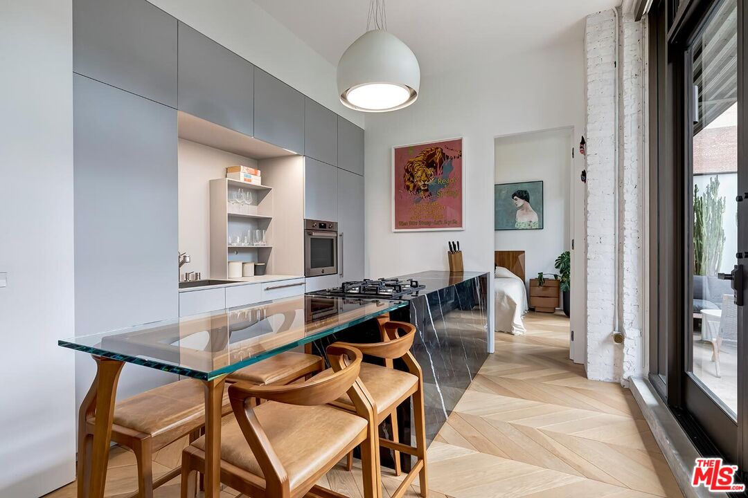 460 South Spring Street, Unit 201 Los Angeles, CA 90013 - Photo 6 of 27 a living room with furniture a large window and wood floor