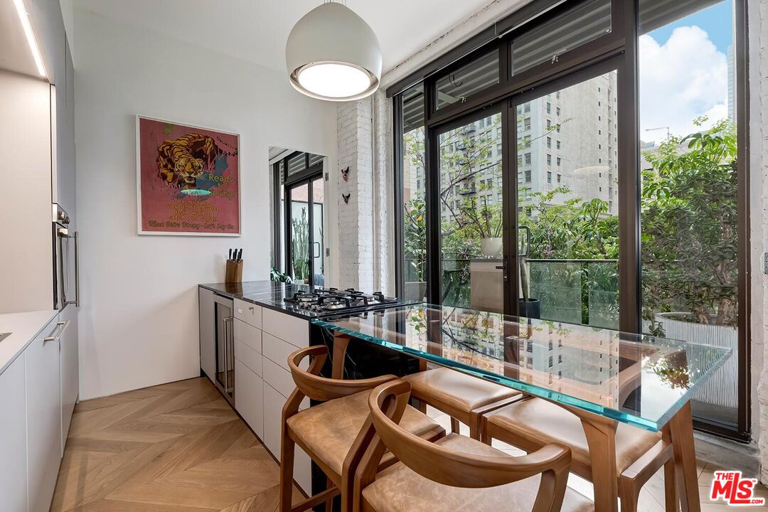 460 South Spring Street, Unit 201 Los Angeles, CA 90013 - Photo 7 of 27 a dining room with furniture and a floor to ceiling window