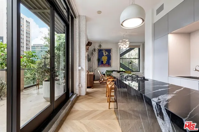 a living room with furniture a rug and a large window