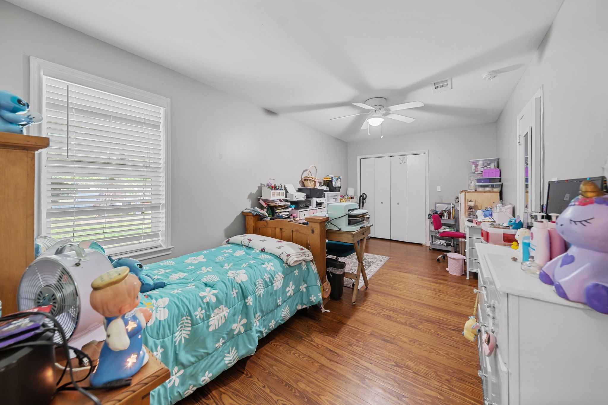 202 Sweed Street Brenham, TX 77833 - Photo 16 of 34 a bedroom with furniture and a wooden floor