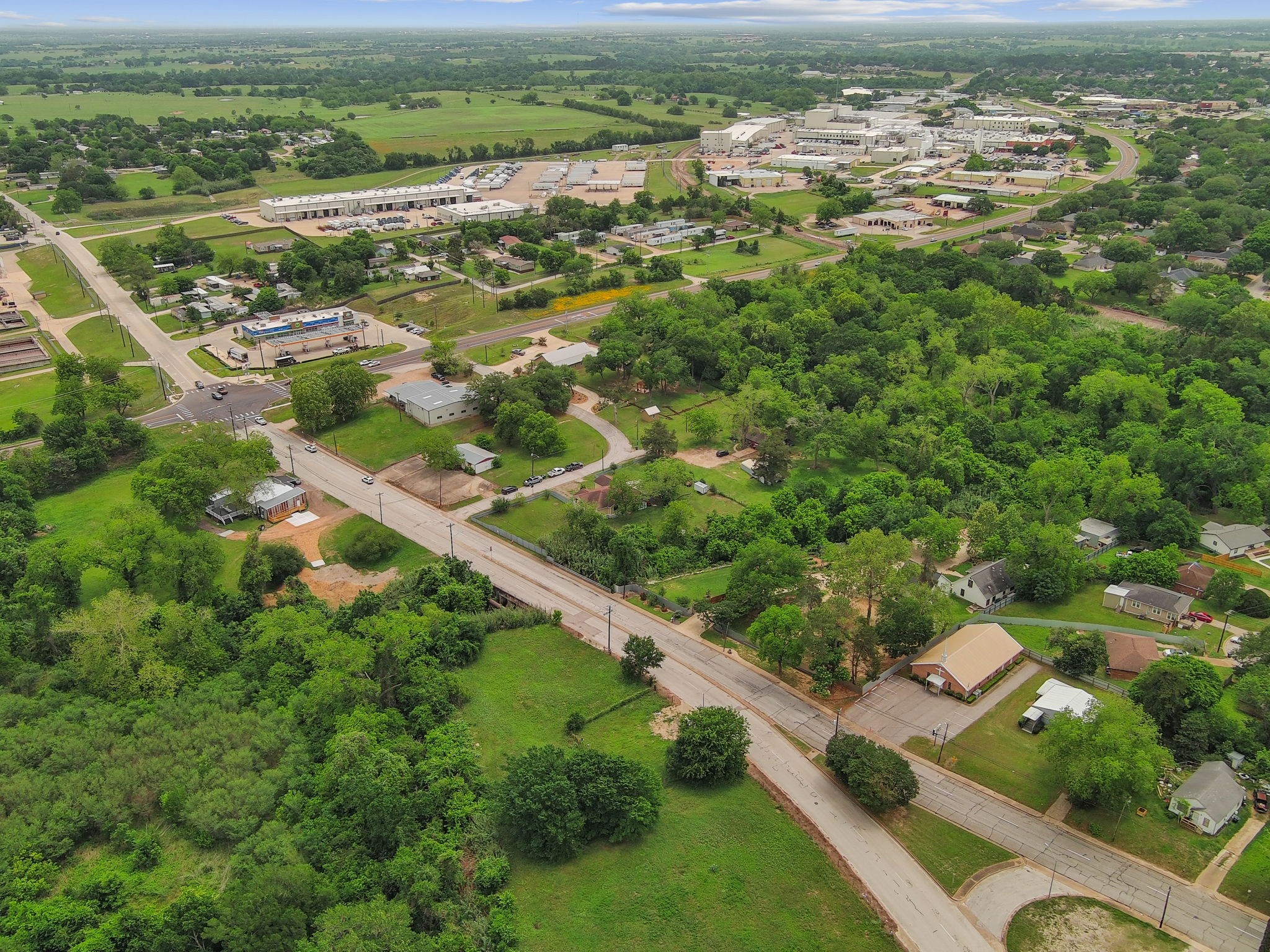 202 Sweed Street Brenham, TX 77833 - Photo 32 of 34 an aerial view of residential houses with outdoor space and trees