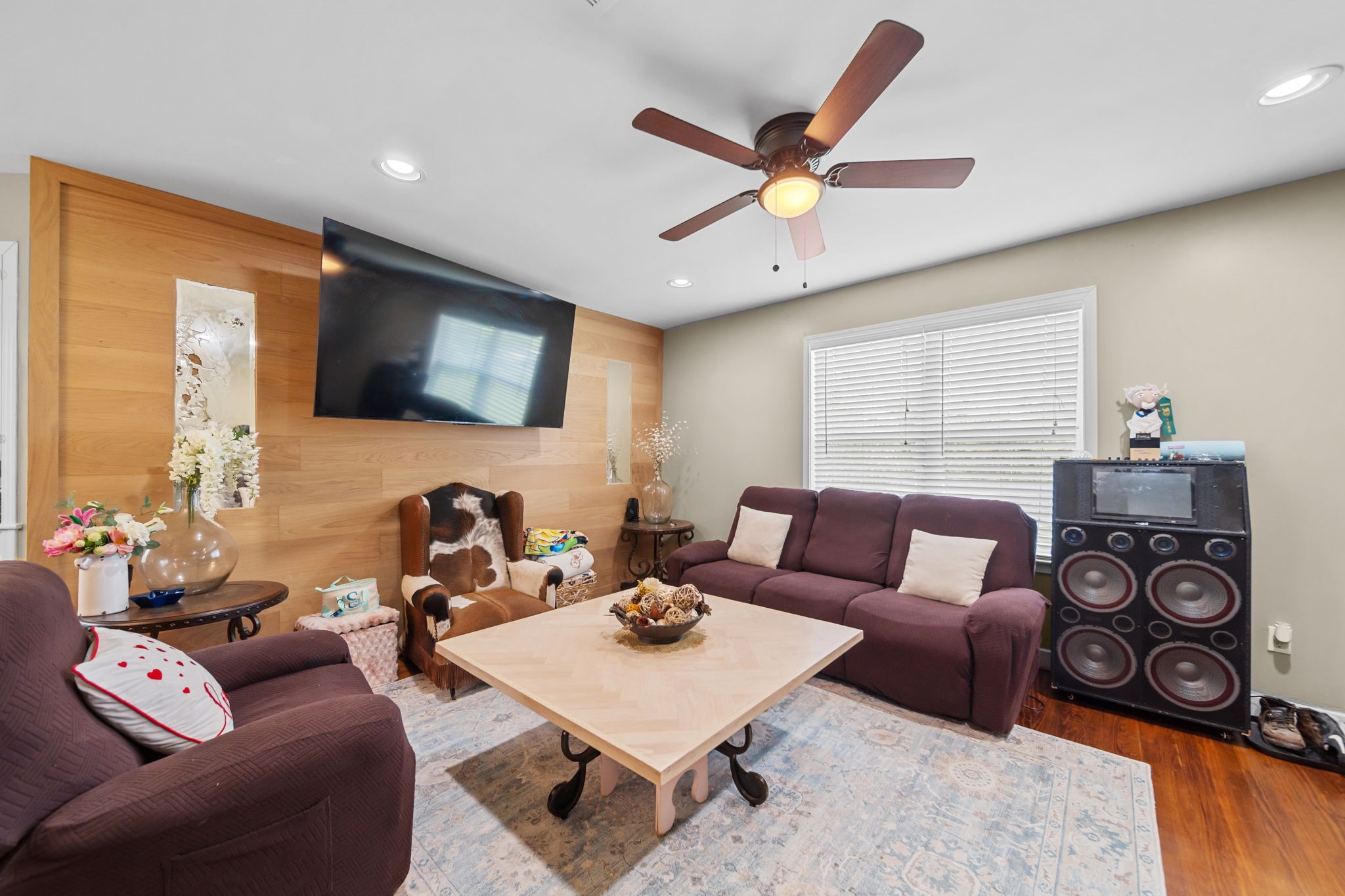 202 Sweed Street Brenham, TX 77833 - Photo 5 of 34 a living room with furniture a window and a flat screen tv