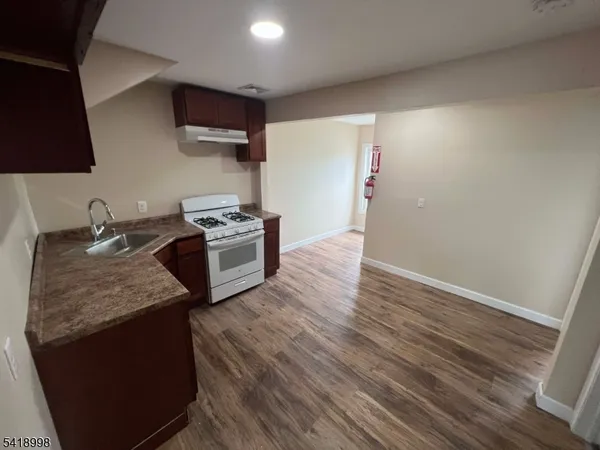 a kitchen with a sink stove and refrigerator