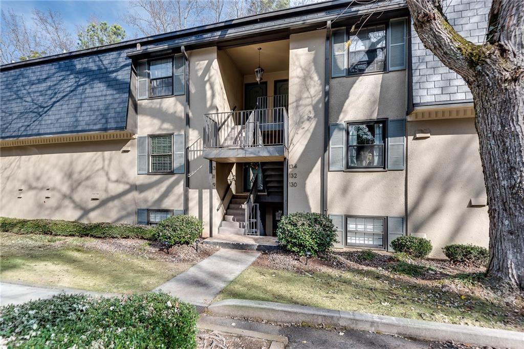 134 Lablanc Way Northwest Atlanta, GA 30327 - Photo 2 of 42 a front view of a house with garden