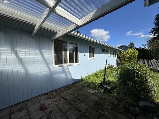 a backyard of a house with flower plants