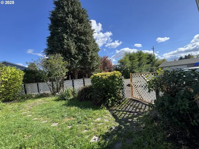 a backyard of a house with lots of green space and garden