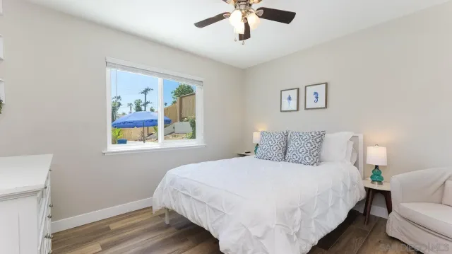 a bedroom with a bed and a painting on the wall