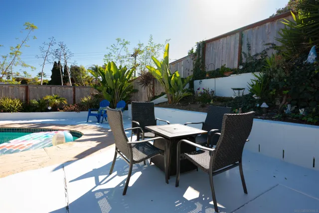 a view of a backyard with plants and a patio