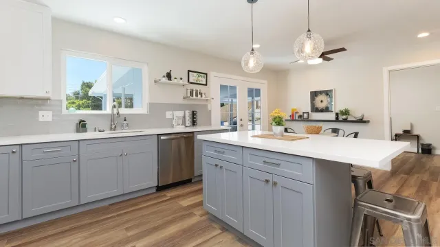 a spacious bathroom with a double vanity sink a mirror and a bathtub