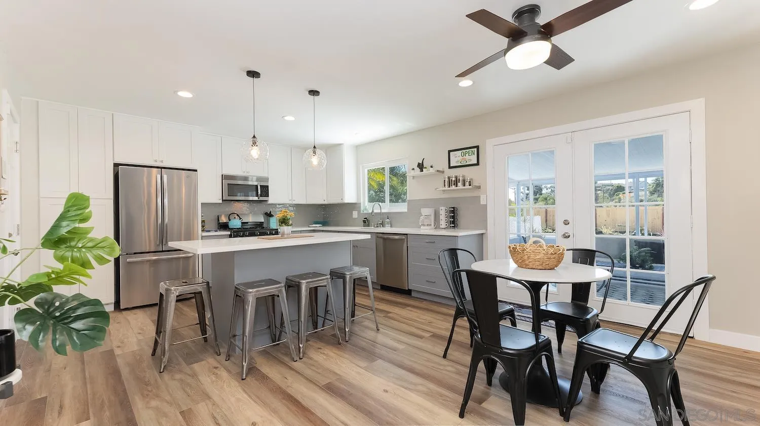 Undisclosed Address Oceanside, CA 92054 - Photo 9 of 19 a kitchen with a dining table chairs refrigerator and cabinets