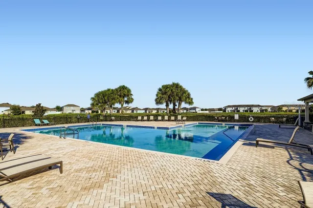 a view of swimming pool with outdoor seating