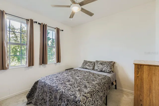 a bedroom with a bed and window