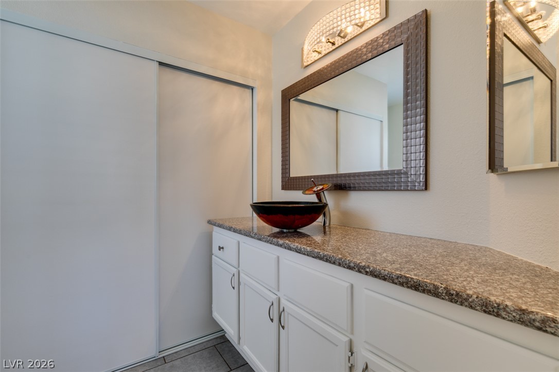 2028 Rustler Ridge Avenue North Las Vegas, NV 89031 - Photo 33 of 40 Vessel sink and granite countertops complement this functional bathroom space.