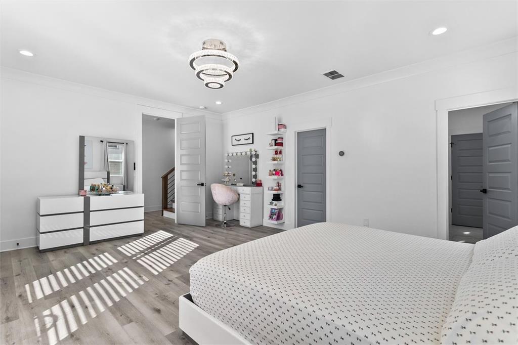 658 Rockbridge Road Northwest Lilburn, GA 30047 - Photo 17 of 61 a bedroom with a white bed and white walls
