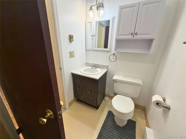 a bathroom with a sink toilet and mirror