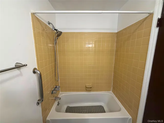 a bathroom with a shower and a sink