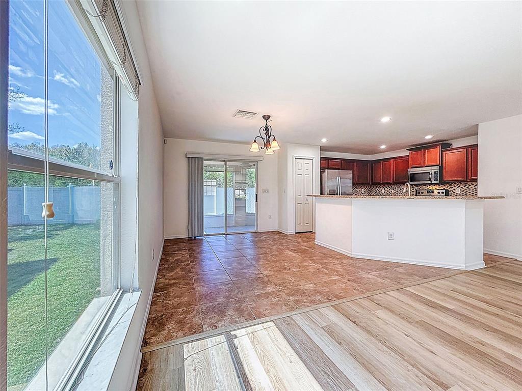 5101 Chipotle Lane Wesley Chapel, FL 33544 - Photo 12 of 25 a view of a kitchen with kitchen island wooden floor and window