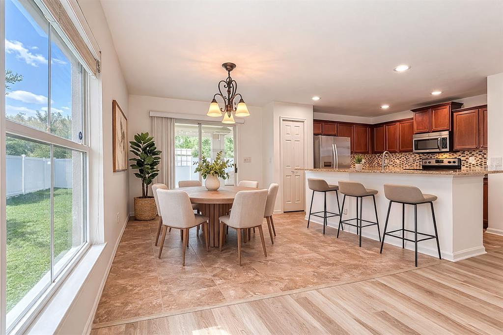 5101 Chipotle Lane Wesley Chapel, FL 33544 - Photo 13 of 25 a view of a dining room with furniture window and wooden floor