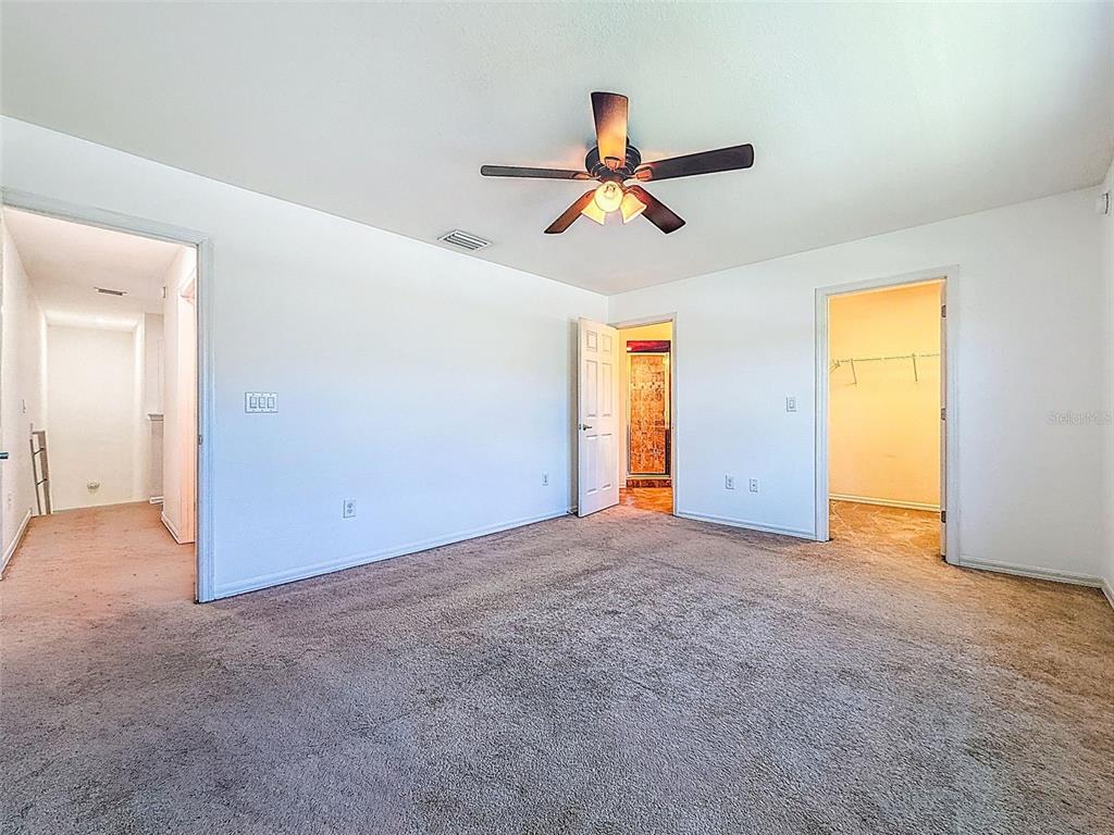 5101 Chipotle Lane Wesley Chapel, FL 33544 - Photo 16 of 25 an empty room with a window and a ceiling fan