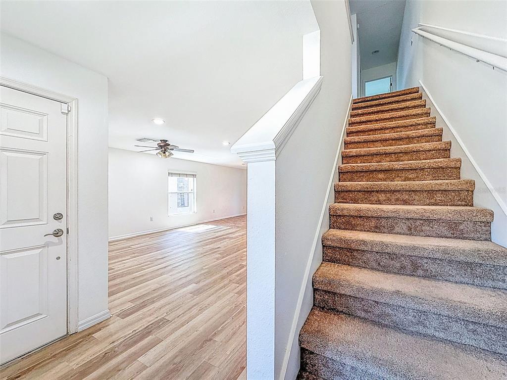 5101 Chipotle Lane Wesley Chapel, FL 33544 - Photo 9 of 25 a view of a hallway with wooden floor and entryway