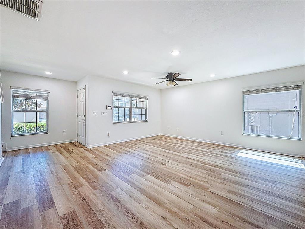 5101 Chipotle Lane Wesley Chapel, FL 33544 - Photo 10 of 25 an empty room with wooden floor and windows