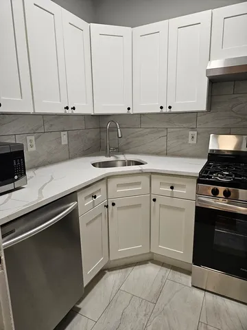 a kitchen with a sink and cabinets