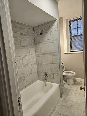 a bathroom with a bathtub and toilet
