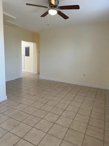 an empty room with windows and closet