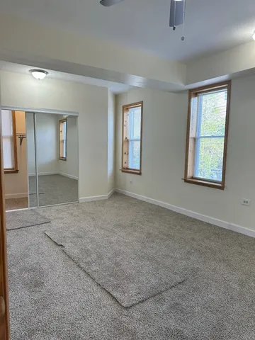 a view of a hallway with wooden floor and stairs