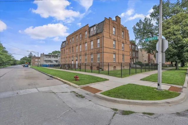 a view of a big building with a big yard and potted plants