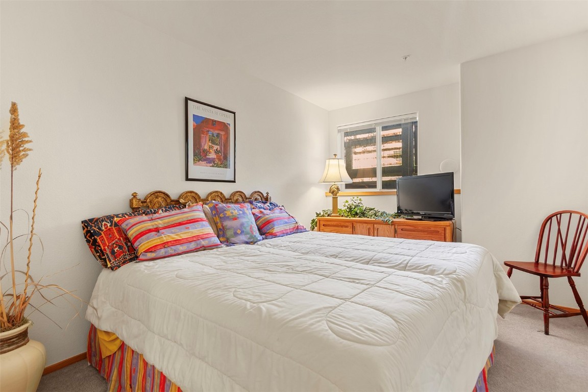 91299 Ryan Gulch Road, Unit A4 Wildernest, CO 80498 - Photo 14 of 30 a bedroom with a bed and chair