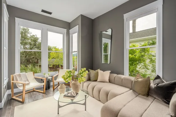 a balcony with furniture and a potted plant