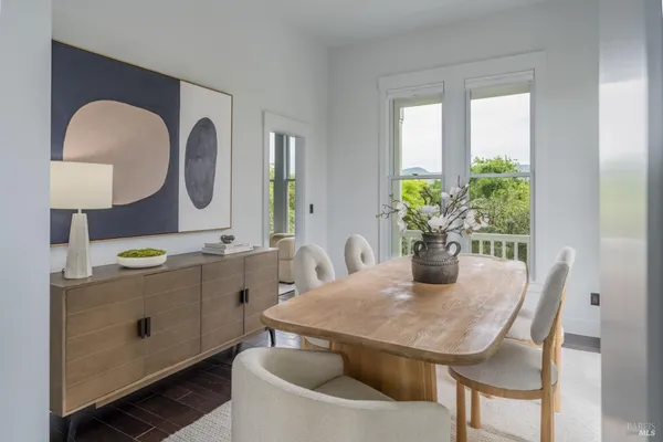 a dining hall with granite countertop a couch and a view of living room