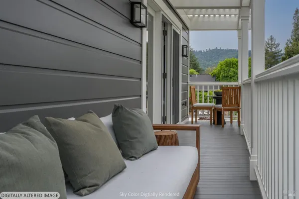 a dining hall with granite countertop a couch and a view of living room