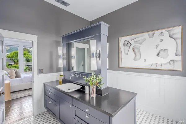 a bathroom with a tub sink and mirror