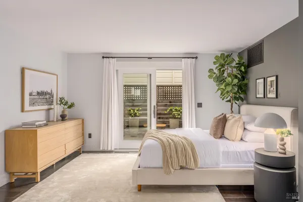 a living room with furniture a mirror and a potted plant