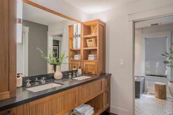 a bathroom with a sink a toilet a shower and a mirror
