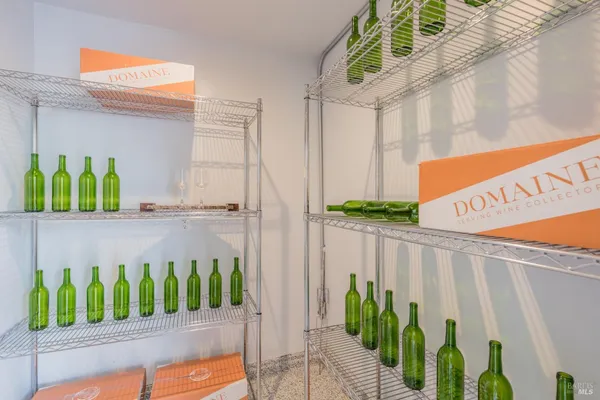 a view of a white house with large windows and a small yard