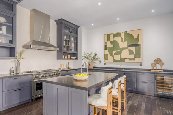 a kitchen with a sink cabinets and wooden floor