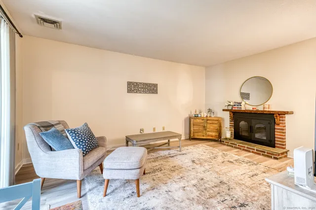 a living room with furniture a fireplace and a fireplace