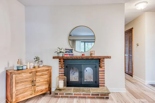 a view of living room with furniture and a mirror