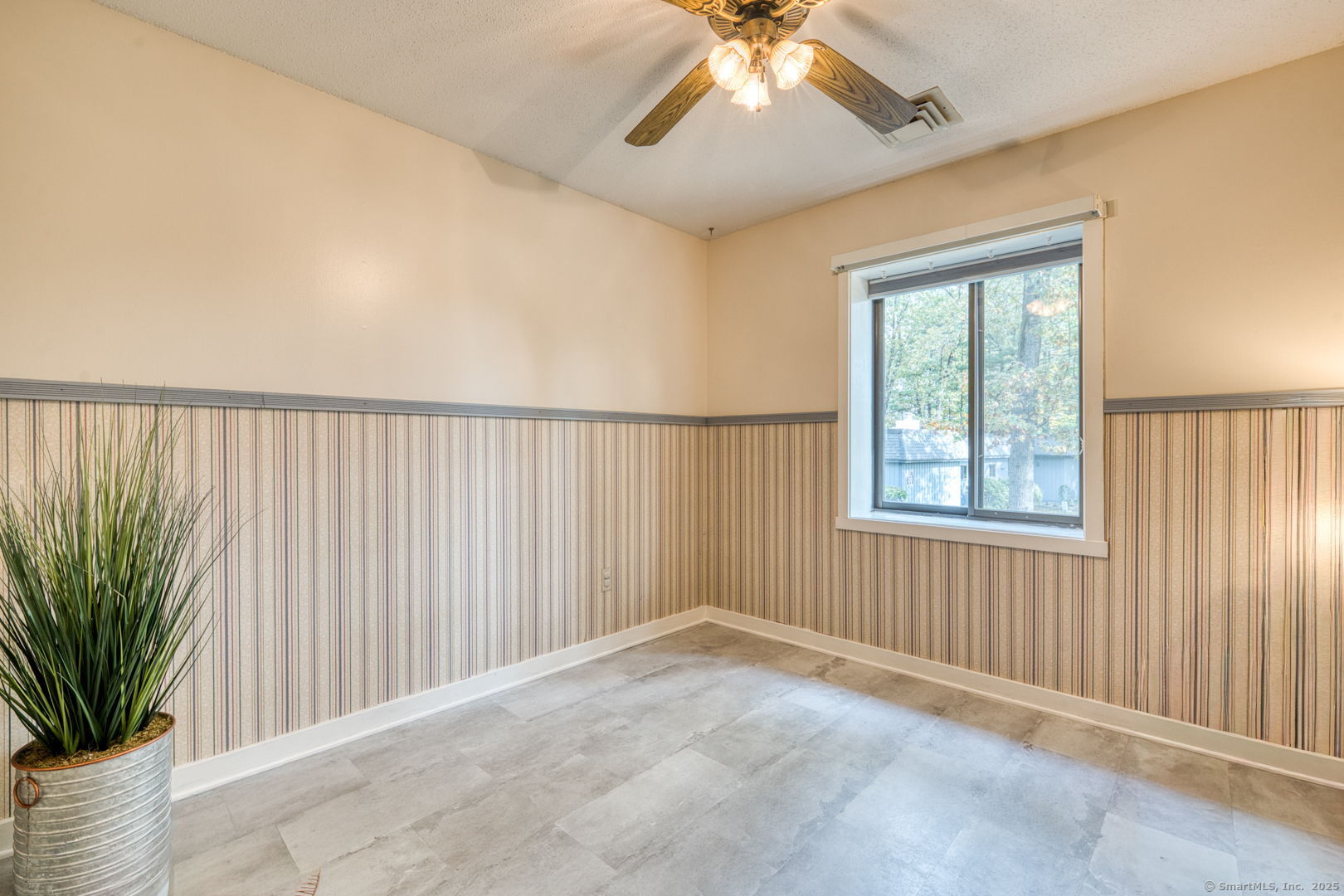 10 Deepwood Drive, Unit 10 Southington, CT 06489 - Photo 12 of 31 an empty room with windows and chandelier fan