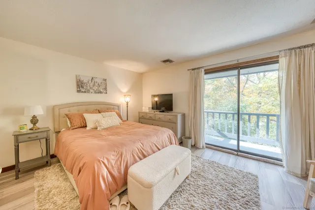 a bedroom with a large bed and a window