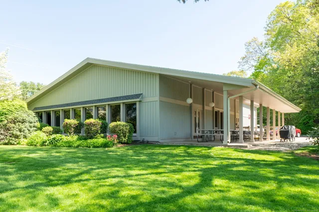 a front view of house with yard and green space