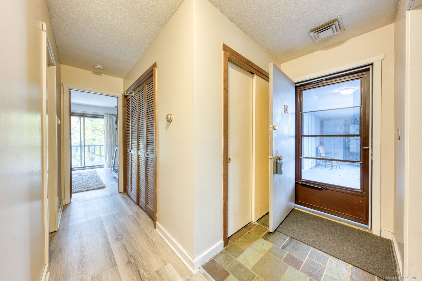 10 Deepwood Drive, Unit 10 Southington, CT 06489 - Photo 4 of 31 a view of a hallway with wooden floor and closet area