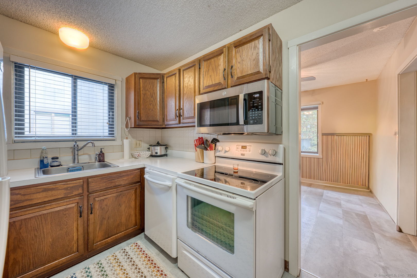10 Deepwood Drive, Unit 10 Southington, CT 06489 - Photo 6 of 31 a kitchen with stainless steel appliances a stove sink microwave and cabinets
