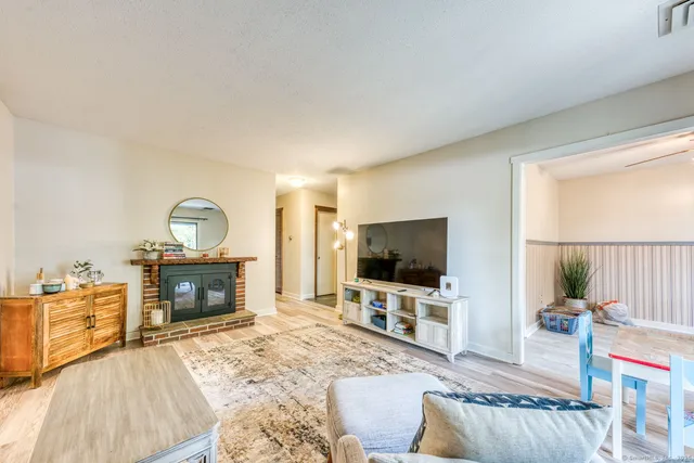 a living room with furniture a flat screen tv and a fireplace