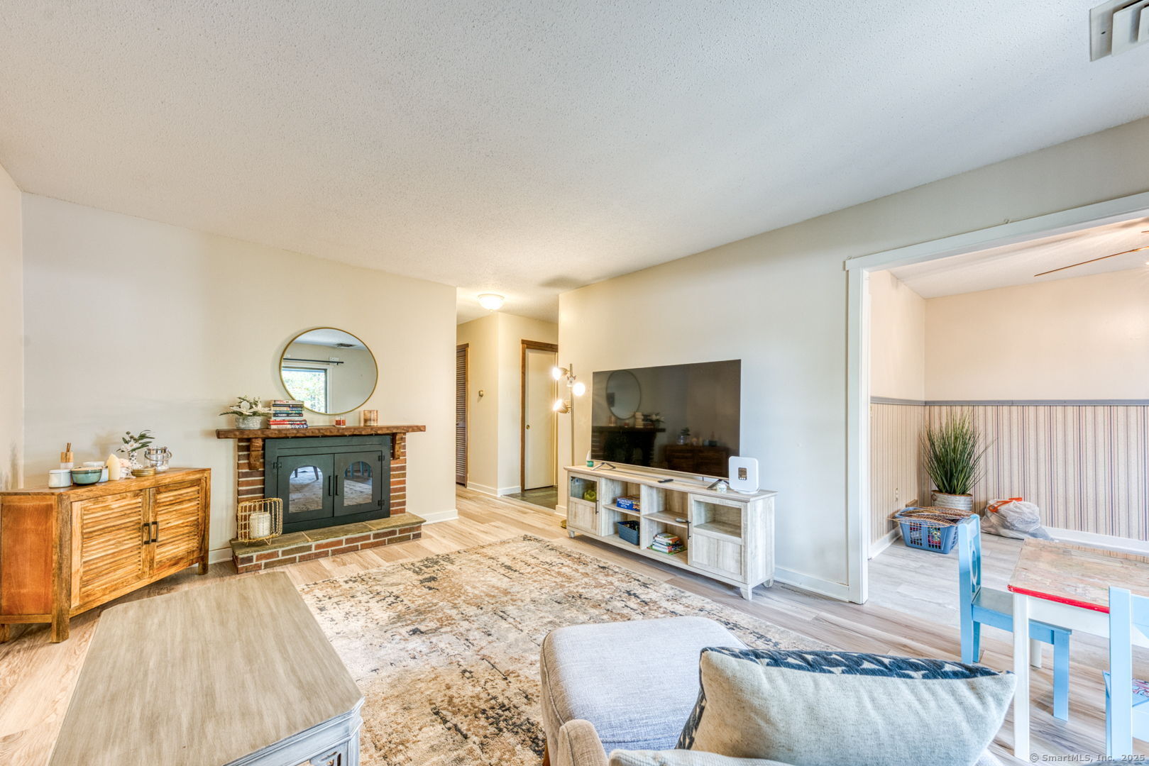 10 Deepwood Drive, Unit 10 Southington, CT 06489 - Photo 7 of 31 a living room with furniture a flat screen tv and a fireplace