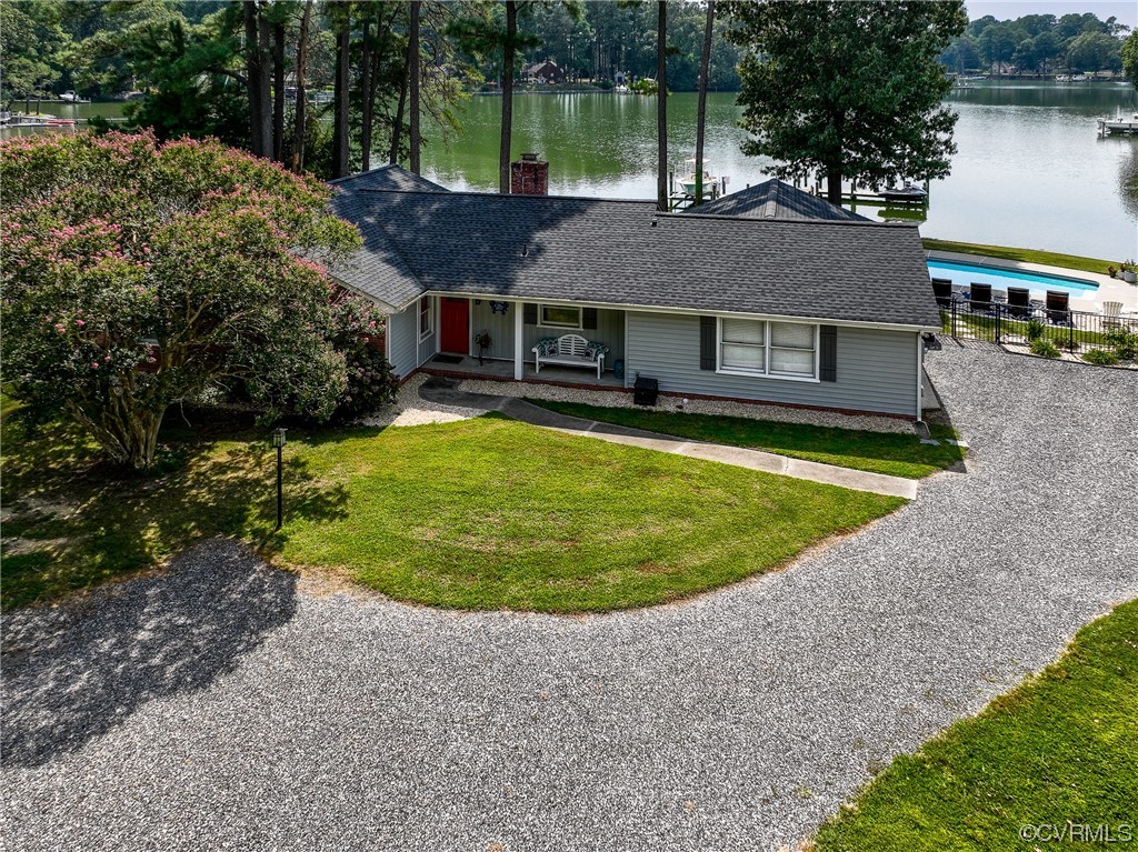 a view of a house with a swimming pool and a yard