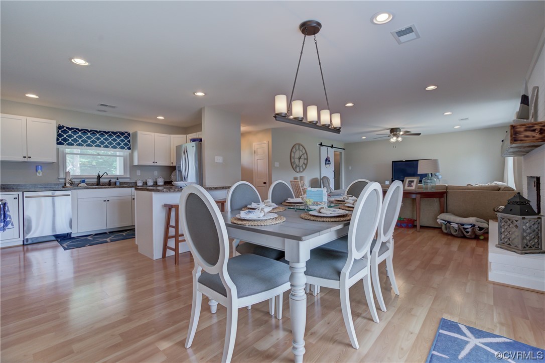 20 South Sioux Road Kilmarnock, VA 22482 - Photo 21 of 46 a view of a dining room and livingroom with furniture wooden floor a chandelier